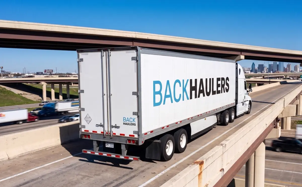 Backhaulers dry van trailer crossing an urban interchange